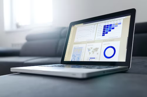 A laptop screen displaying blue graphics representing data analysis. The laptop is positioned open, with the screen facing the viewer. On the screen, there are visual representations of data analysis, depicted in various shades of blue. The graphics may include charts, graphs, or other visualizations commonly used for data analysis. The specific details of the visualizations cannot be discerned from the alt text, but the emphasis is on the blue color scheme and the indication that data analysis is being presented on the laptop screen.