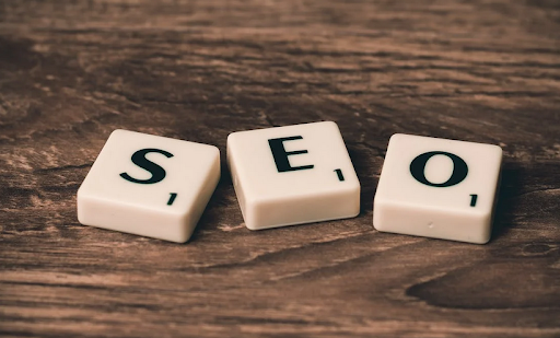 Three wooden pieces displaying the letters S, E, and O, representing SEO. The alt text describes wooden pieces arranged side by side, with each piece featuring a single letter. The letters spell out S-E-O, which is an acronym for Search Engine Optimization (SEO). The wooden pieces may be individual blocks or part of a larger structure or display. The focus is on the arrangement and representation of the letters S, E, and O on the wooden pieces.